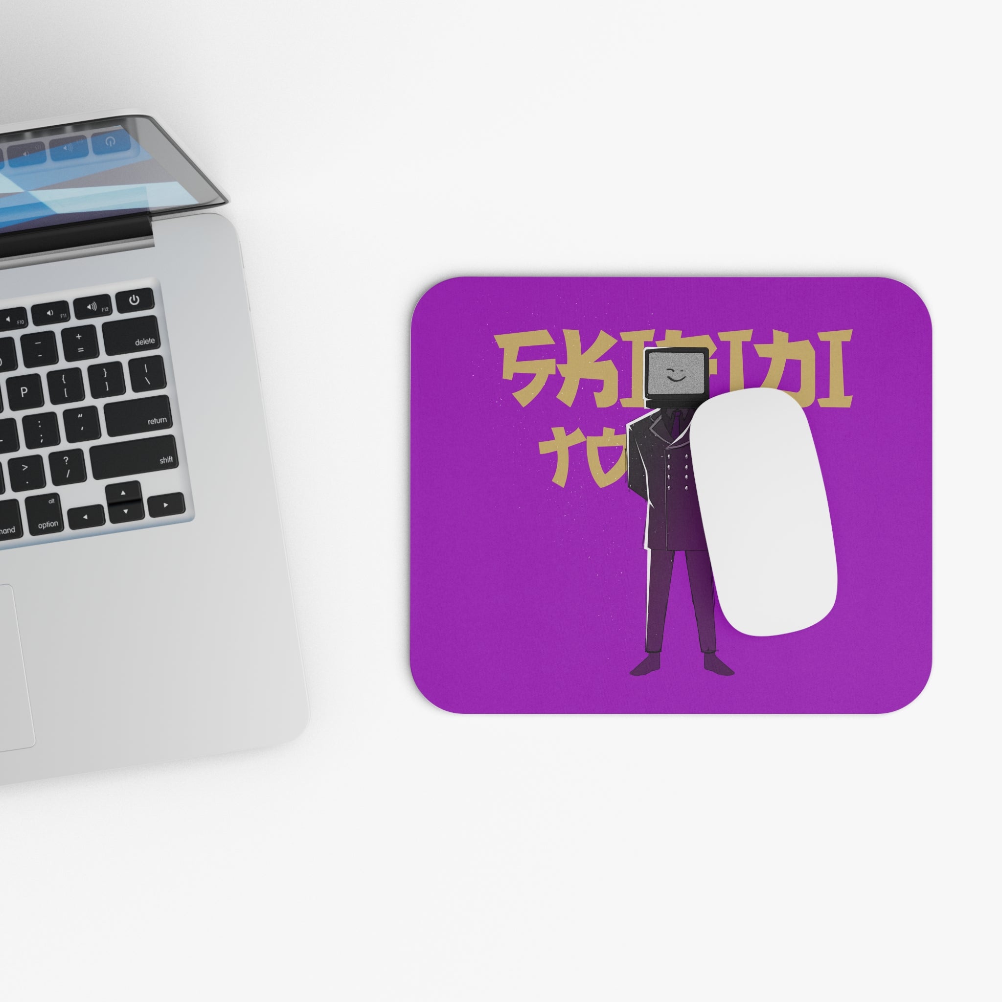 purple mousepad featuring TV Man and gold text with mouse and laptop